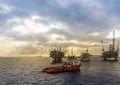 An anchor handling tug boat maneuvering at an oil production platform at Terengganu oil field