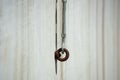 Anchor hook with a metal rust ring in a concrete wall, soft focus