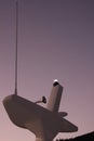 Anchor light, horn and radio antenna atop the mast of a catamaran