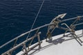 Anchor and stairs on board the yacht, white deck, blue sea Royalty Free Stock Photo