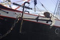 Anchor of a tall ship, hanging by the board Royalty Free Stock Photo