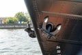 Anchor and waterline at the bow of the black painted ship Royalty Free Stock Photo