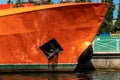 Anchor and waterline at the bow of the orange painted ship Royalty Free Stock Photo