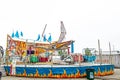 Anchorage Alaska USA Carnival ride - Sizzler whiling seats in brightly colored ride with flags and neon lights and