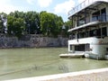 Anchored boat with the monumental mural of William Kentridge along the Tiber to Rome in Italy.