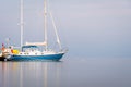 Anchored Caribbean sailboat at dusk on isolated simple background