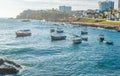 Anchored fishing boats by the sea on the shore of Praia do Rio Vermelho in Salvador, Brazil