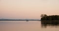 Anchored sailboat on a lake with mountains in the background at sunset Royalty Free Stock Photo