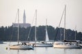 Anchored sailboats in front of Saint Euphemia bell tower