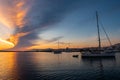 Anchored sailboats with magnificent sunrise with saturated orange and purple bank of clouds in the sky in Naoussa Village on Paros Royalty Free Stock Photo