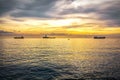 Anchored ships waiting their turn to enter in the port at sunrise Royalty Free Stock Photo