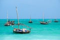 Anchored Traditional wooden dhow boats on the amazing turquoise water in the Indian ocean at Nungwi village, Zanzibar Royalty Free Stock Photo