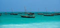 Anchored Traditional wooden dhow boats on the amazing turquoise water in the Indian ocean at Nungwi village, Zanzibar Royalty Free Stock Photo