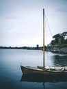 A lone sailboat on deep blue water