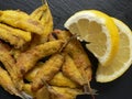 Anchovies battered with flour and fried with lemon Royalty Free Stock Photo