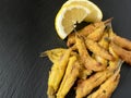 Anchovies battered with flour and fried with lemon Royalty Free Stock Photo
