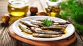 Anchovies marinated in olive oil and cooked at low temperature on a white plate. Royalty Free Stock Photo