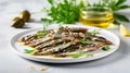 Anchovies marinated in olive oil and cooked at low temperature on a white plate. Royalty Free Stock Photo