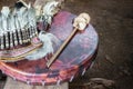 Ancient amerindian tambourine, drum drumstick replica and a feather headdress.