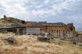 Ancient antique amphitheater in city of Hierapolis in Turkey. Side view. Steps and antique statues with columns in the