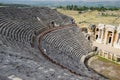 Ancient antique amphitheater in city of Hierapolis in Turkey. Steps and antique statues with columns in the amphitheater