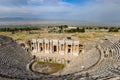 Ancient antique amphitheater in city of Hierapolis in Turkey. Steps and antique statues with columns in the amphitheater Royalty Free Stock Photo