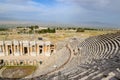 Ancient antique amphitheater in city of Hierapolis in Turkey. Steps and antique statues with columns in the amphitheater Royalty Free Stock Photo