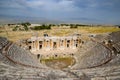 Ancient antique amphitheater in city of Hierapolis in Turkey. Steps and antique statues with columns in the amphitheater Royalty Free Stock Photo