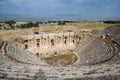 Ancient antique amphitheater in city of Hierapolis in Turkey. Steps and antique statues with columns in the amphitheater Royalty Free Stock Photo
