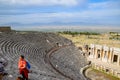 Ancient antique amphitheater in city of Hierapolis in Turkey. Steps and antique statues with columns in the amphitheater