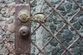 Ancient antique bronze door with iron chain knob. Royalty Free Stock Photo
