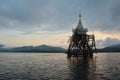 Ancient antique ruins ubosot Wat wang wiwekaram temple drown underwater of Songkalia river at sunset dawn for thai people and