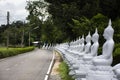 Ancient antique white buddha statue on beside road street for thai people traveler travel visit and respect praying blessing holy Royalty Free Stock Photo