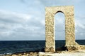 Ancient arch - ruins over seashore, front view Royalty Free Stock Photo