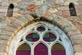 Ancient arched glass windows installed in a stone castle wall Royalty Free Stock Photo