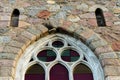 Ancient arched glass windows installed in a stone castle wall Royalty Free Stock Photo