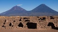 ancient archeology of stone houses with a volcano in the background in high resolution