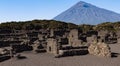 ancient archeology of stone houses with a volcano in the background in high resolution and sharpness