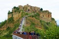 Civita di Bagnoregio, Italy - May 1, 2019: Tourists visiting the unique hilltop Italian Village