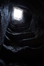 Ancient artificial tunnel in the mountain with steps vertical