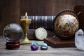 Ancient astrology. Old astrology globe and books with lighting candle Royalty Free Stock Photo