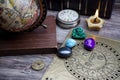 Ancient astrology. Old astrology globe and books with lighting candle Royalty Free Stock Photo