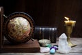 Ancient astrology. Old astrology globe and books with lighting candle Royalty Free Stock Photo