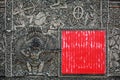 Ancient Balinese stone carving background with the red square shield