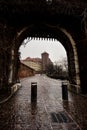 ancient barbican, silhouetted by external light, Wawel castle in the background,