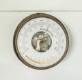 Ancient barometer on white wooden wall for weather measurement interior home and living decoration collection retro style Royalty Free Stock Photo