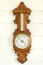 Ancient barometer on white wooden wall for weather measurement interior home and living decoration collection retro style Royalty Free Stock Photo