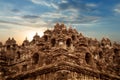 Ancient bas-reliefs, sculptures and statues on the walls of the Borobudur temple against sunrise. Indonesia.