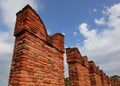 Ancient Battlements with crenellations on the wall made with old bricks Royalty Free Stock Photo