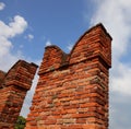 Ancient Battlements with crenellations on the wall made with old bricks Royalty Free Stock Photo